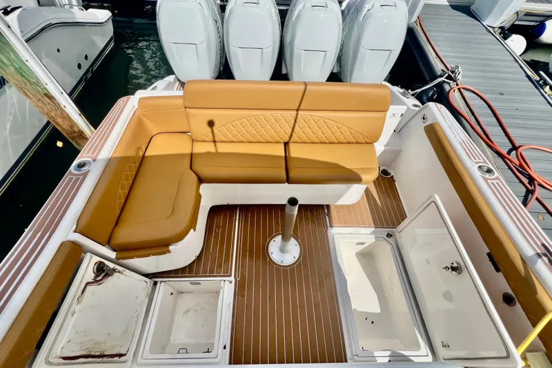 Slide: The Image of 2011 Deep Impact 36 Open boat interior with tan seating and multiple storage compartments. - 31
