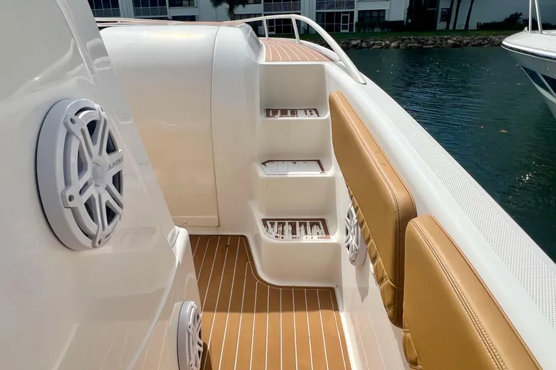 Slide: The Image of Interior view of 2011 Deep Impact 36 Open boat with tan seating and marine speakers. - 34