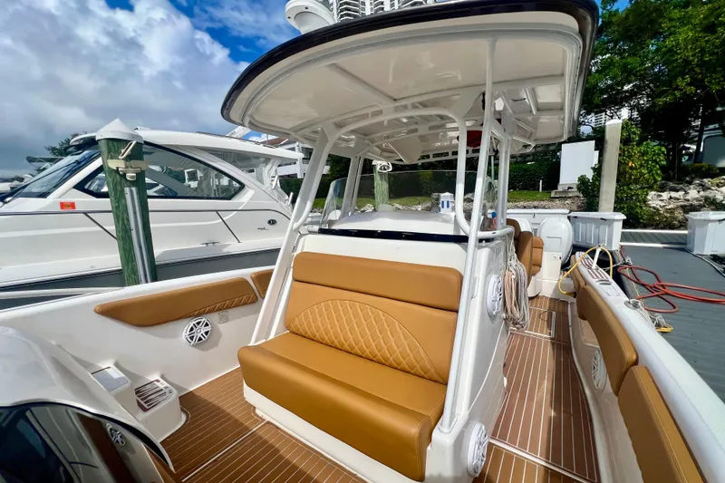 Slide: The Image of 2011 Deep Impact 36 Open boat with tan seating and sleek design at dock. - 37