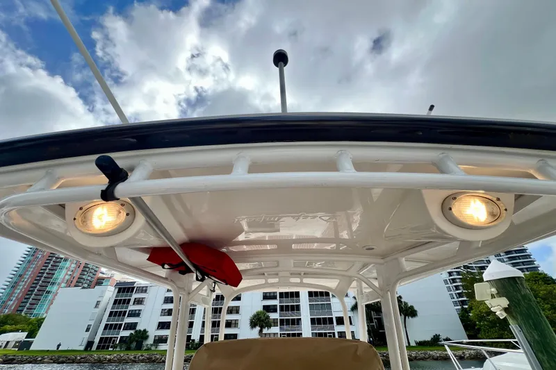 Slide: The Image of 2011 Deep Impact 36 Open boat canopy with lights, against a cloudy sky backdrop. - 38