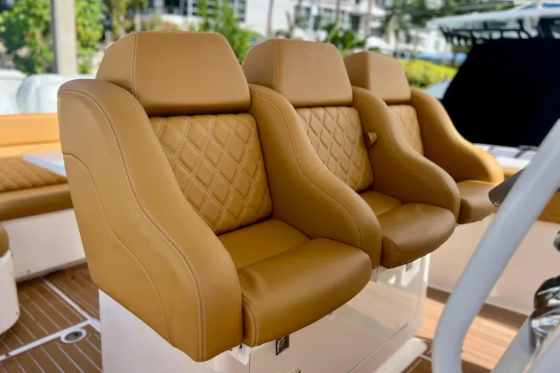 Slide: The Image of Luxurious tan leather seats on a 2011 Deep Impact 36 Open boat. - 39