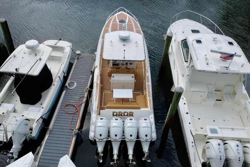 Slide: The Image of 2011 Deep Impact 36 Open boat docked between two other boats. - 4
