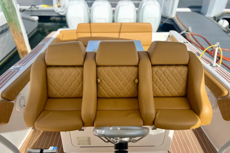 Slide: The Image of Luxurious tan leather seating on a 2011 Deep Impact 36 Open boat. - 40