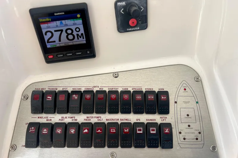 Slide: The Image of Control panel of a 2011 Deep Impact 36 Open boat with Garmin display and switches. - 42