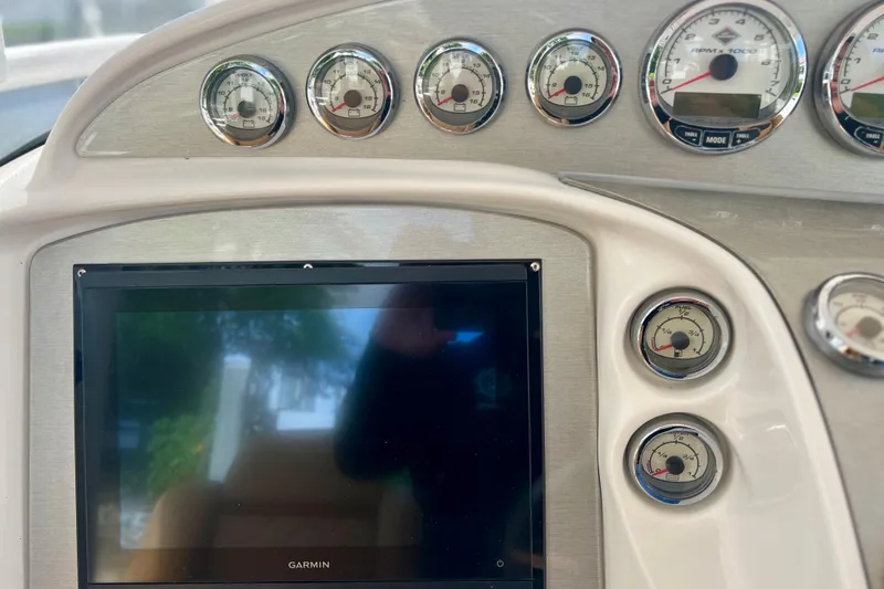 Slide: The Image of Dashboard of a 2011 Deep Impact 36 Open boat with gauges and Garmin display. - 43