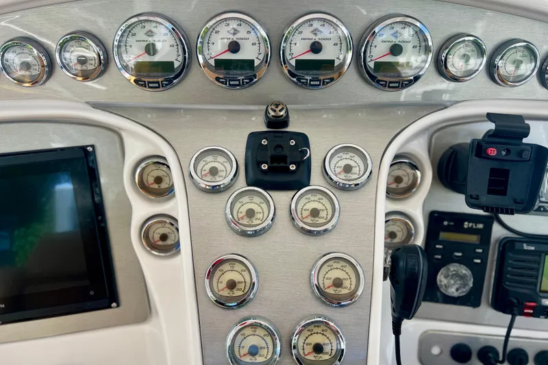Slide: The Image of Dashboard of a 2011 Deep Impact 36 Open boat with gauges and controls. - 44
