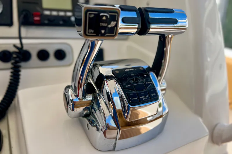 Slide: The Image of Chrome throttle controls on a 2011 Deep Impact 36 Open boat dashboard. - 47