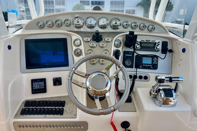 Slide: The Image of Control panel of a 2011 Deep Impact 36 Open boat with steering wheel and gauges. - 48