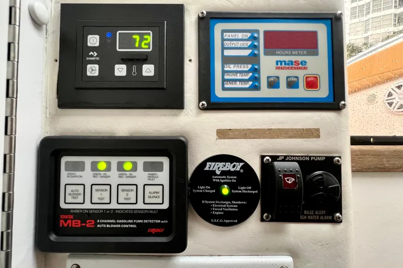 Slide: The Image of Control panel of a 2011 Deep Impact 36 Open boat with various gauges and switches. - 56