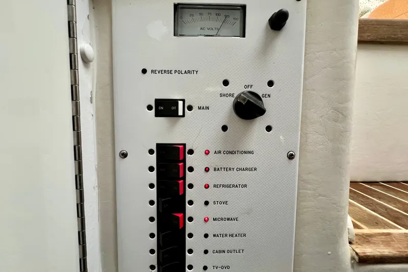Slide: The Image of Electrical control panel on a 2011 Deep Impact 36 Open boat, featuring various switches and indicators. - 57