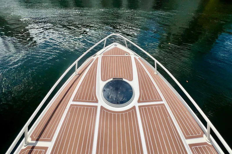 Slide: The Image of Bow view of 2011 Deep Impact 36 Open boat on calm water. - 6
