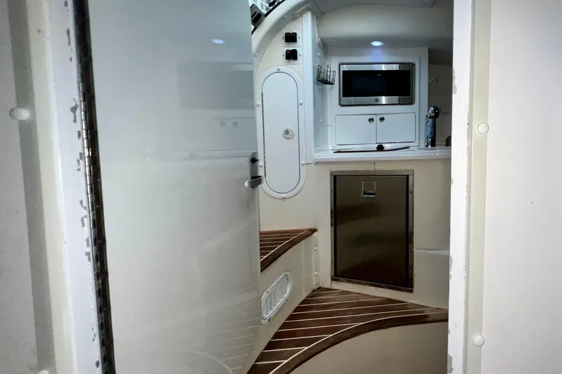 Slide: The Image of Interior of 2011 Deep Impact 36 Open boat with kitchenette and wooden flooring. - 63