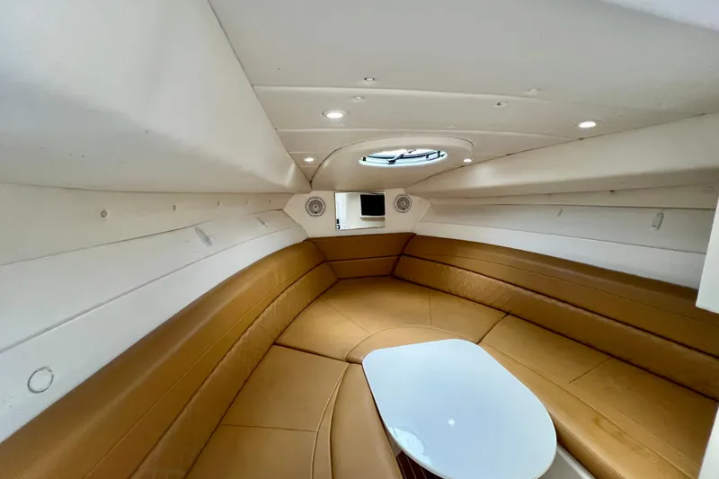 Slide: The Image of Interior cabin of 2011 Deep Impact 36 Open boat with tan seating and white table. - 64