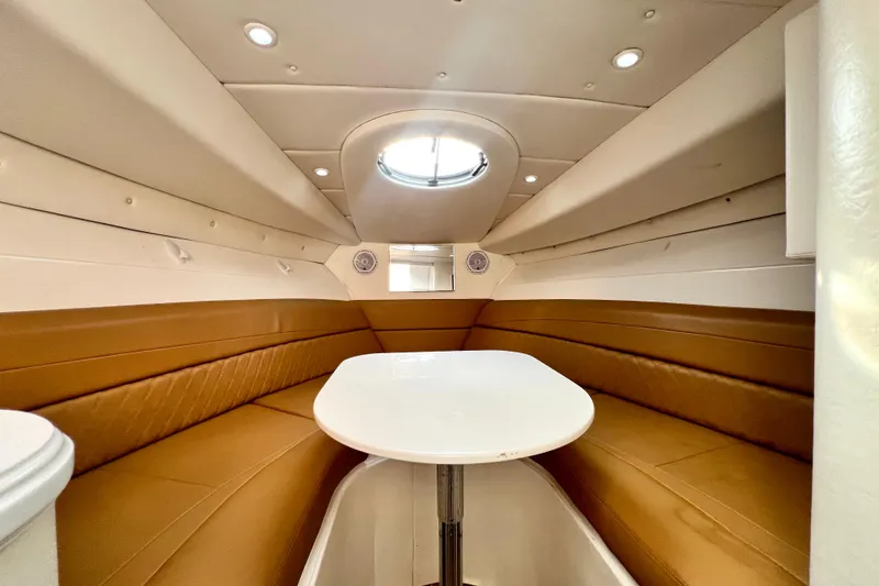 Slide: The Image of Luxurious cabin interior of 2011 Deep Impact 36 Open boat with tan seating and white table. - 67