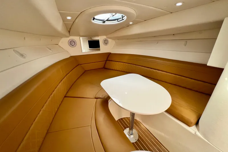 Slide: The Image of Luxurious interior of 2011 Deep Impact 36 Open boat with brown seating and white table. - 68