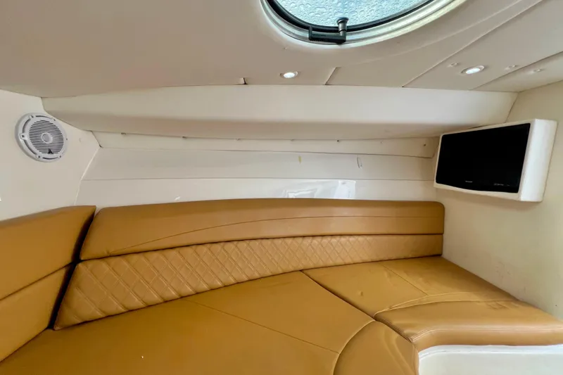 Slide: The Image of Interior of 2011 Deep Impact 36 Open boat with tan seating and wall-mounted TV. - 71