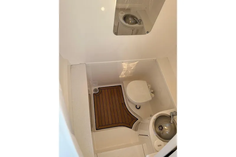 Slide: The Image of 2013 Intrepid 375 Center Console boat bathroom with sink and toilet. - 16