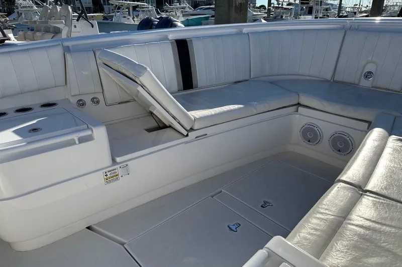 Slide: The Image of 2013 Intrepid 375 Center Console boat interior with cushioned seating and storage compartments. - 19