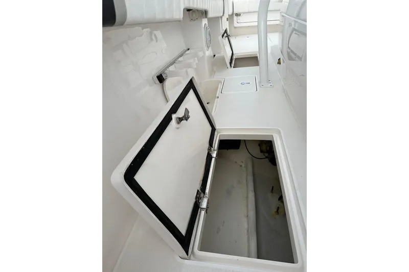 Slide: The Image of 2013 Intrepid 375 Center Console open storage compartment on deck. - 42