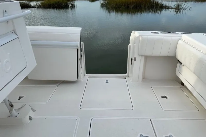 Slide: The Image of 2013 Intrepid 375 Center Console boat deck with white seating and water view. - 31