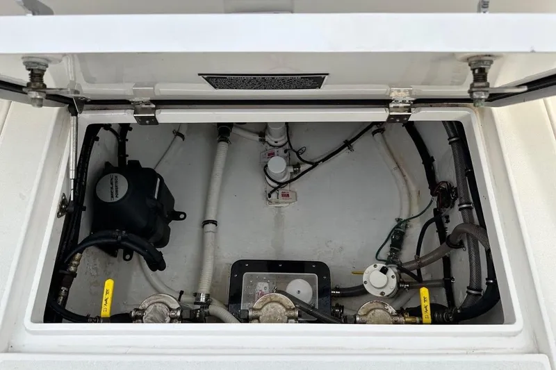 Slide: The Image of 2013 Intrepid 375 Center Console boat compartment with visible wiring and components. - 35