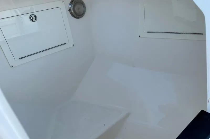 Slide: The Image of Interior view of a 2013 Intrepid 375 Center Console boat, featuring storage compartments. - 28