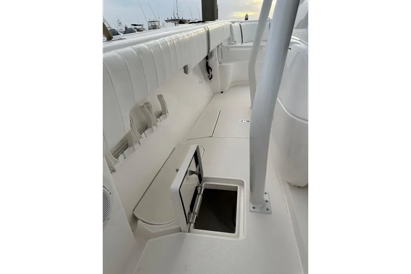 Slide: The Image of 2013 Intrepid 375 Center Console interior with storage compartment and rod holders. - 43