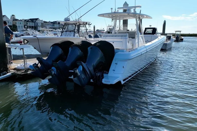 Slide: The Image of 2013 Intrepid 375 Center Console boat docked with triple outboard engines. - 5
