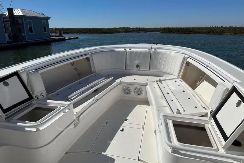 Slide: The Image of 2013 Intrepid 375 Center Console boat interior with open storage compartments and seating. - 25
