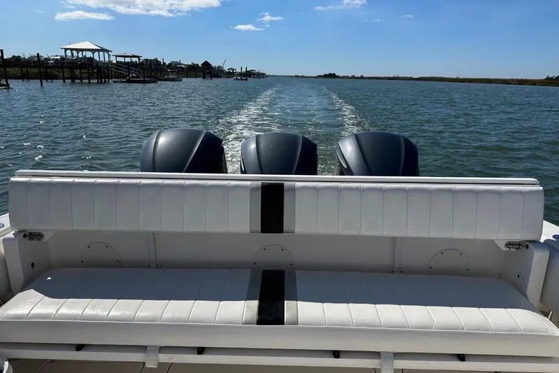 Slide: The Image of 2013 Intrepid 375 Center Console boat with triple engines on open water. - 12