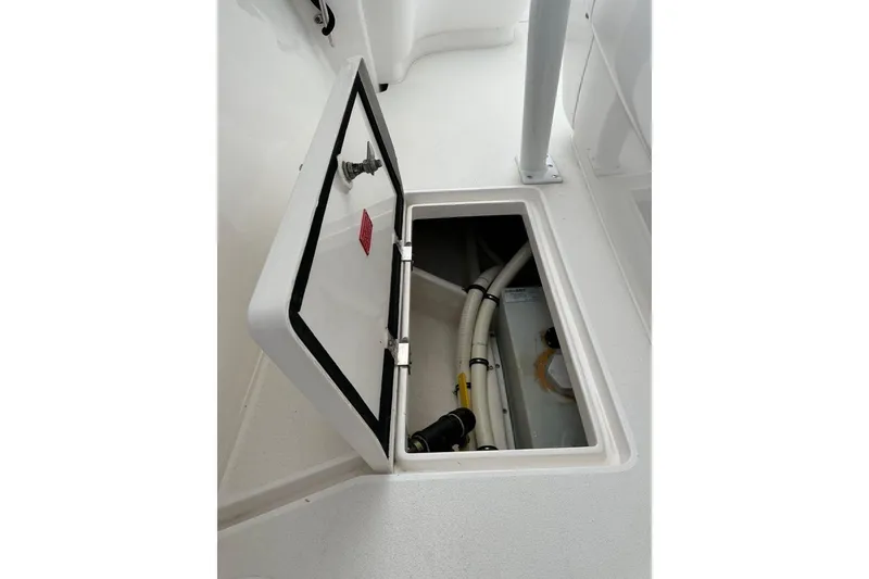 Slide: The Image of Open hatch on 2013 Intrepid 375 Center Console boat, revealing internal components. - 44