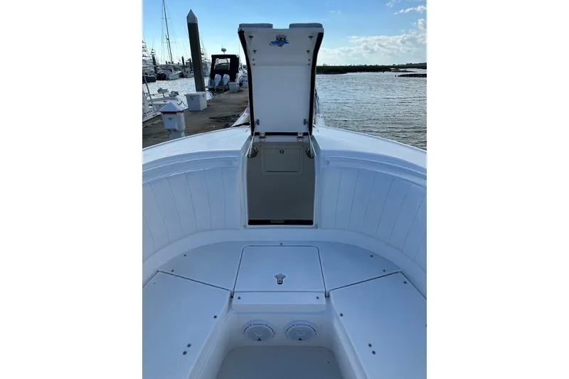 Slide: The Image of 2013 Intrepid 375 Center Console boat with open storage compartment, docked by the water. - 27