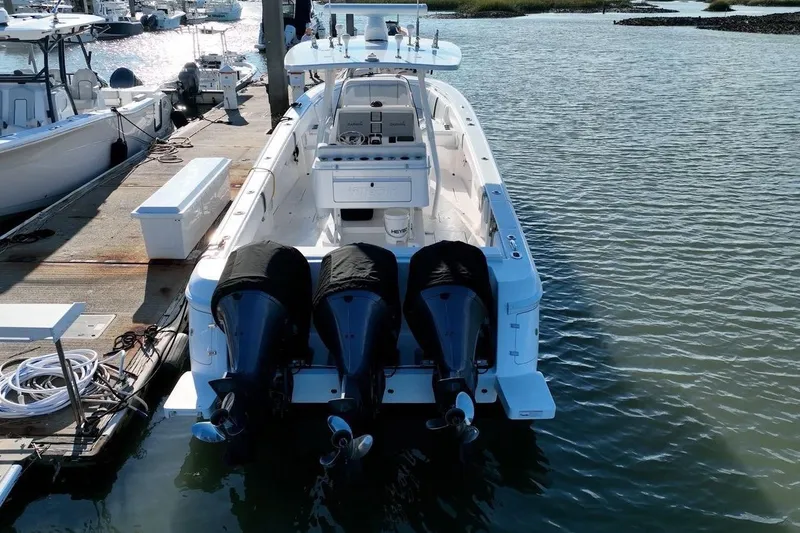 Slide: The Image of 2013 Intrepid 375 Center Console boat docked with triple outboard engines. - 4