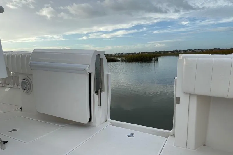 Slide: The Image of 2013 Intrepid 375 Center Console boat with open deck, overlooking serene water and sky. - 30