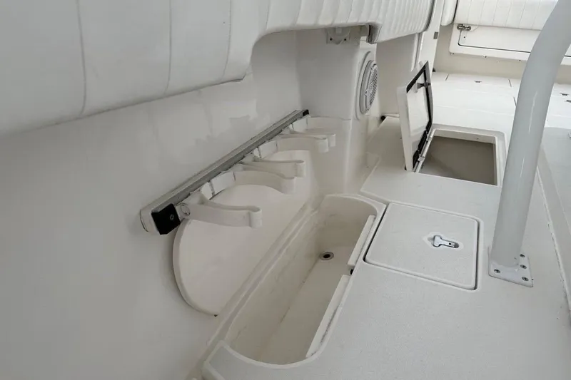 Slide: The Image of 2013 Intrepid 375 Center Console interior with storage compartments and rod holders. - 40