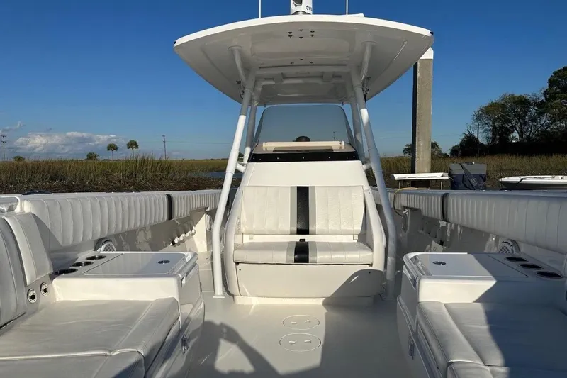 Slide: The Image of 2013 Intrepid 375 Center Console boat interior with white seating and open deck. - 21