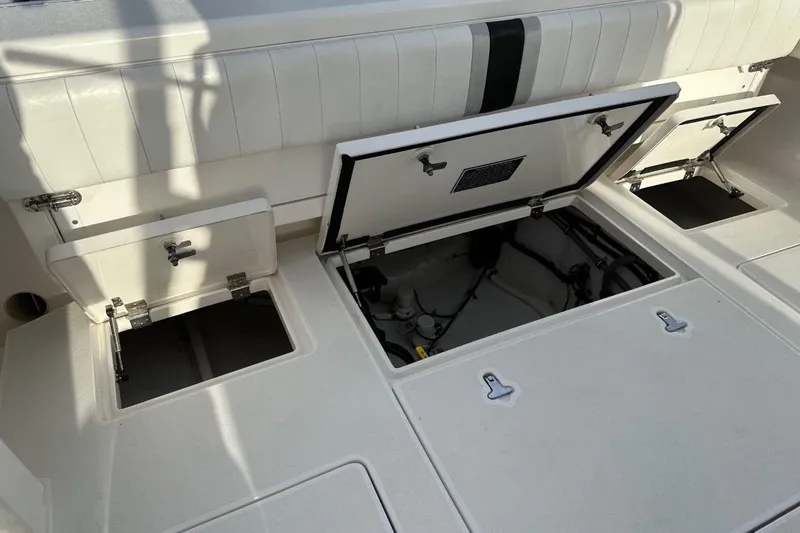 Slide: The Image of Open storage compartments on a 2013 Intrepid 375 Center Console boat deck. - 33