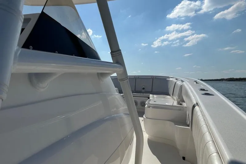 Slide: The Image of 2013 Intrepid 375 Center Console boat on water under clear blue sky. - 18
