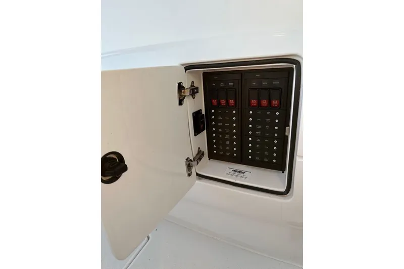 Slide: The Image of Electrical panel inside a 2013 Intrepid 375 Center Console boat, with open access door. - 14
