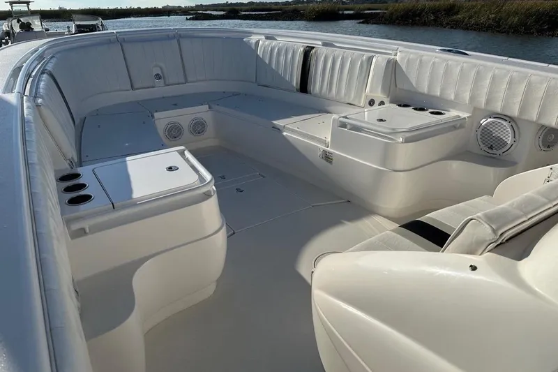 Slide: The Image of 2013 Intrepid 375 Center Console boat interior with white seating and cup holders. - 17