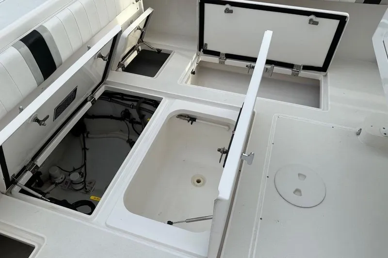 Slide: The Image of Open storage compartments on a 2013 Intrepid 375 Center Console boat deck. - 38