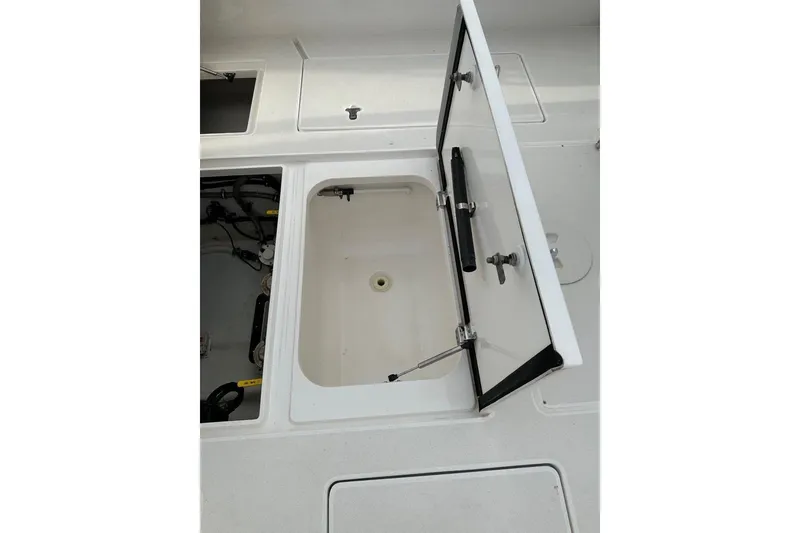 Slide: The Image of Open storage compartment on a 2013 Intrepid 375 Center Console boat. - 36