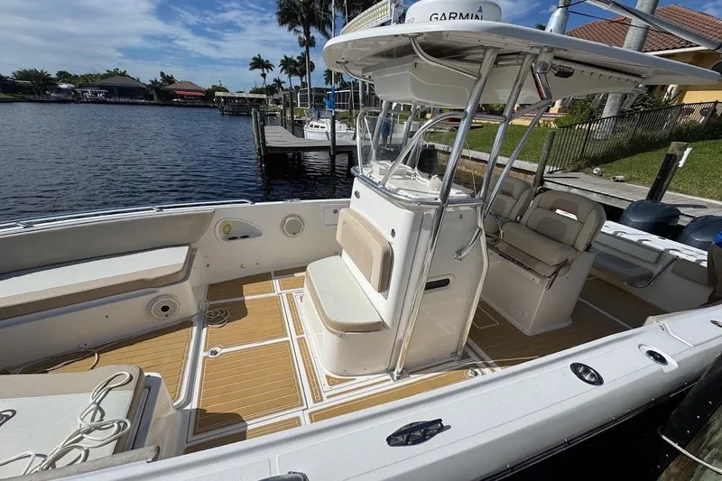 Slide: The Image of 2014 Stamas 317 Tarpon boat with spacious deck and seating, docked by waterfront. - 10