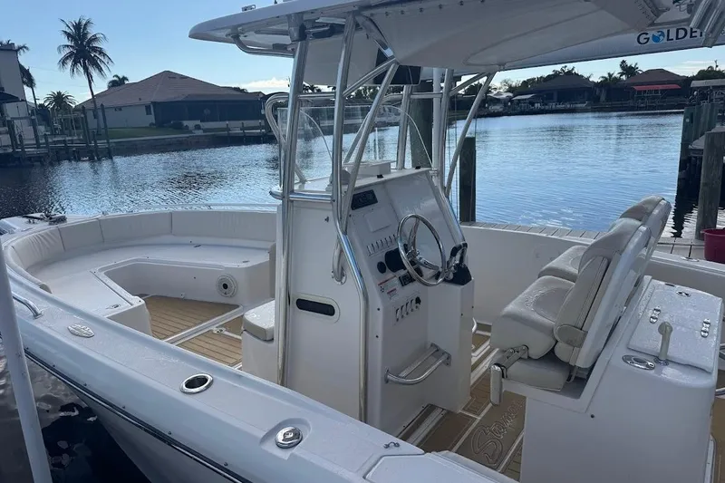 Slide: The Image of 2014 Stamas 317 Tarpon boat with helm, docked by waterfront homes. - 16