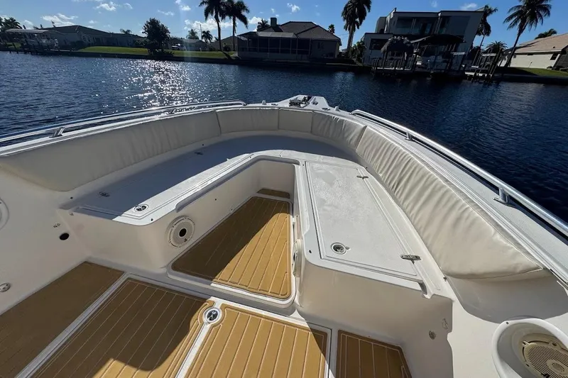 Slide: The Image of 2014 Stamas 317 Tarpon boat interior with cushioned seating and wooden flooring. - 18