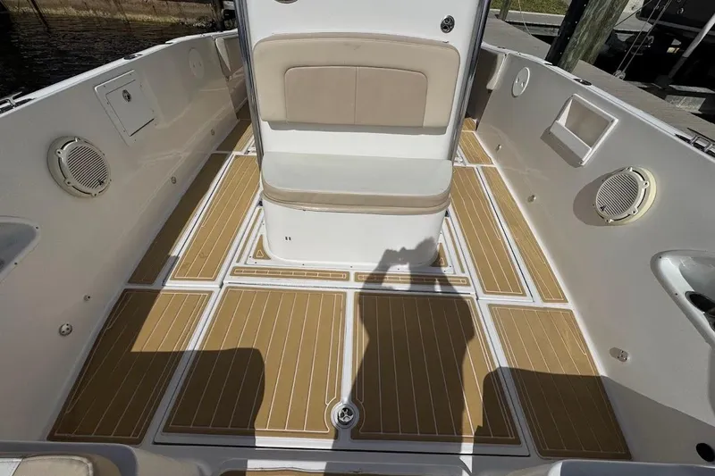 Slide: The Image of 2014 Stamas 317 Tarpon boat interior with tan cushioned seating and teak-style flooring. - 30