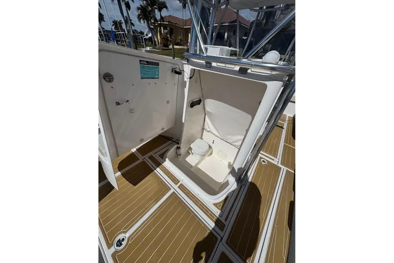 Slide: The Image of 2014 Stamas 317 Tarpon boat interior with open compartment and wooden deck flooring. - 32