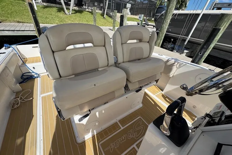 Slide: The Image of 2014 Stamas 317 Tarpon boat interior with dual beige seats and wooden flooring. - 34