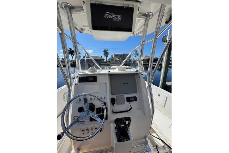 Slide: The Image of 2014 Stamas 317 Tarpon boat console with steering wheel and Garmin navigation system. - 36