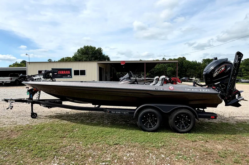 Slide: The Image of 2026 Skeeter ZXE21 boat on trailer, parked outside a Yamaha dealership. - 1